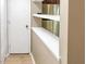 Hallway with wood floors and shelves, offering ample storage space at 5810 Shady Grove Cir, Raleigh, NC 27609