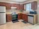 Spacious kitchen featuring stainless steel appliances, wood cabinets, and ample counter space at 5810 Shady Grove Cir, Raleigh, NC 27609