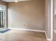 The empty living room features light wood floors and a sliding glass door at 5810 Shady Grove Cir, Raleigh, NC 27609