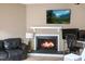 Cozy living room with a fireplace, TV, and workspace at 5810 Shady Grove Cir, Raleigh, NC 27609