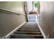 View of the staircase with gray carpet leading to an open door at 5810 Shady Grove Cir, Raleigh, NC 27609