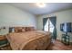 Bedroom with dark wood floors and a window with curtains at 6501 Battleford Dr, Raleigh, NC 27613