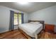 Bright bedroom with wood floors, a window, and neutral walls at 6501 Battleford Dr, Raleigh, NC 27613