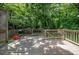 Wood deck with a grill, overlooking a wooded backyard at 6501 Battleford Dr, Raleigh, NC 27613