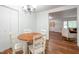 Cozy dining area with wood floors, a chandelier, and views of the living room at 6501 Battleford Dr, Raleigh, NC 27613