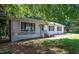 Charming brick home with a white porch and well-maintained lawn at 6501 Battleford Dr, Raleigh, NC 27613
