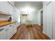 Eat-in kitchen with white cabinets, wood countertops, a dining area, and a laundry closet at 6501 Battleford Dr, Raleigh, NC 27613