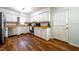 Well-lit kitchen with white cabinets, stainless steel appliances, hardwood floors, and butcher block countertops at 6501 Battleford Dr, Raleigh, NC 27613