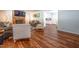 Comfortable living room features a brick fireplace, plush seating, hardwood floors, and an open flow to the kitchen at 6501 Battleford Dr, Raleigh, NC 27613