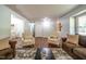 Spacious living room featuring hardwood floors, comfortable seating, neutral color scheme, and access to other rooms at 6501 Battleford Dr, Raleigh, NC 27613