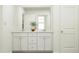 Bright bathroom with a double sink vanity, large mirror, and neutral color palette at 66 Digging Time Ave, Princeton, NC 27569