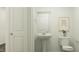 Bathroom with pedestal sink, toilet, mirror, and decor at 66 Digging Time Ave, Princeton, NC 27569