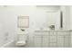 Bright bathroom featuring double sinks, white cabinetry, and a shower-tub combo at 66 Digging Time Ave, Princeton, NC 27569