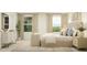 Stylish bedroom with dresser, a cushioned bench, luxurious bed, and ample natural light at 66 Digging Time Ave, Princeton, NC 27569