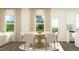 Open-concept dining area with a wooden table and chairs, great natural light, and modern decor at 66 Digging Time Ave, Princeton, NC 27569