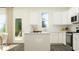 Bright, modern kitchen featuring white cabinets, island, stainless steel appliances, and backyard views at 66 Digging Time Ave, Princeton, NC 27569