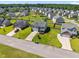 Aerial view of a neighborhood featuring single-Gathering homes with green lawns and mature trees at 737 Botanical Ct, Bunnlevel, NC 28323
