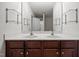Bathroom features dual sinks, sleek white countertops, and a large mirror, creating a bright and modern space at 737 Botanical Ct, Bunnlevel, NC 28323
