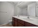 Bathroom features a double sink vanity with rich wood cabinetry and a large mirror, complemented by modern fixtures at 737 Botanical Ct, Bunnlevel, NC 28323