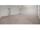 The bedroom has neutral walls and carpet, two windows, and ceiling fan at 737 Botanical Ct, Bunnlevel, NC 28323