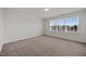 Bright bedroom with neutral carpet, large window offering ample natural light, and freshly painted walls at 737 Botanical Ct, Bunnlevel, NC 28323