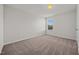 An empty bedroom features neutral carpet, a window, and neutral paint at 737 Botanical Ct, Bunnlevel, NC 28323