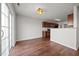 An empty dining room has wood flooring, new lighting, and a sliding glass door at 737 Botanical Ct, Bunnlevel, NC 28323