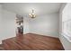 Open dining room featuring wood flooring, natural light, and access to the adjacent kitchen at 737 Botanical Ct, Bunnlevel, NC 28323