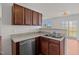 A well-lit kitchen features stainless steel appliances and wood cabinetry at 737 Botanical Ct, Bunnlevel, NC 28323