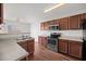 A functional kitchen features wood cabinets, stainless steel appliances, and durable countertops at 737 Botanical Ct, Bunnlevel, NC 28323