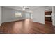 Large living room with hardwood floors, ceiling fan, patio doors, and kitchen access at 737 Botanical Ct, Bunnlevel, NC 28323