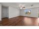 Bright living room featuring hardwood floors, a ceiling fan, and a large window at 737 Botanical Ct, Bunnlevel, NC 28323