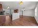 A modern living room has wood floors, a ceiling fan, and new lighting at 737 Botanical Ct, Bunnlevel, NC 28323