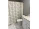 Bathroom featuring a decorative shower curtain, toilet, and white vanity with solid surface counter at 807 W Trinity Ave # 209, Durham, NC 27701