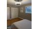 Bedroom featuring white closets and a window, offering ample storage and natural light at 807 W Trinity Ave # 209, Durham, NC 27701