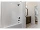 Bright bathroom showcasing a white tiled shower and stylish flooring at 8420 Bells Lake Rd, Apex, NC 27539