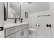 Elegant bathroom featuring white marble floors, gray vanity and large mirror at 8420 Bells Lake Rd, Apex, NC 27539