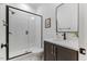Modern bathroom with a glass-enclosed shower, dark vanity, and sleek fixtures at 8420 Bells Lake Rd, Apex, NC 27539