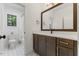 Stylish bathroom features a wood vanity, white countertop, and decorative tile flooring at 8420 Bells Lake Rd, Apex, NC 27539