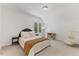 Bright bedroom featuring large bed, dark bedside table and a wood desk at 8420 Bells Lake Rd, Apex, NC 27539