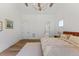 Bright bedroom featuring a modern bed, wood floors, white trim, and recessed lighting at 8420 Bells Lake Rd, Apex, NC 27539