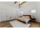 Spacious bedroom featuring a modern bed, wood floors, and recessed lighting at 8420 Bells Lake Rd, Apex, NC 27539