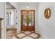 Elegant foyer showcasing decorative tile flooring, glass paneled doors, and a modern light fixture at 8420 Bells Lake Rd, Apex, NC 27539