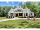 Charming white brick home with a well-manicured lawn, beautiful landscaping, and a welcoming entrance at 8420 Bells Lake Rd, Apex, NC 27539