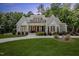 Charming white brick home with a well-manicured lawn, beautiful landscaping, and a welcoming entrance at 8420 Bells Lake Rd, Apex, NC 27539