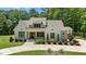 Charming white brick home with a well-manicured lawn, beautiful landscaping, and a welcoming entrance at 8420 Bells Lake Rd, Apex, NC 27539