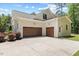 Attached two-car garage boasts paneled doors, concrete driveway, and convenient side-door entry at 8420 Bells Lake Rd, Apex, NC 27539
