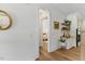 Hallway view with wooden floors, arched doorway, and stylish decor leading to a bedroom at 8420 Bells Lake Rd, Apex, NC 27539