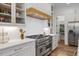 Kitchen boasts stainless appliances, an island, and modern white cabinetry at 8420 Bells Lake Rd, Apex, NC 27539
