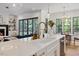 Bright kitchen with hardwood floors and an island overlooking the living and dining rooms at 8420 Bells Lake Rd, Apex, NC 27539